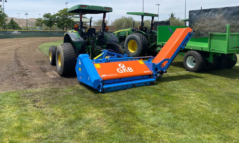 GKB Combinator machine removing natural grass field.